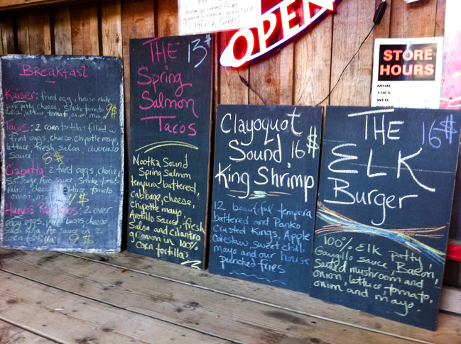 Chalkboards outside a Tofino kitchen listing Clayoquot Sound spring salmon and the elk burger, Tofino